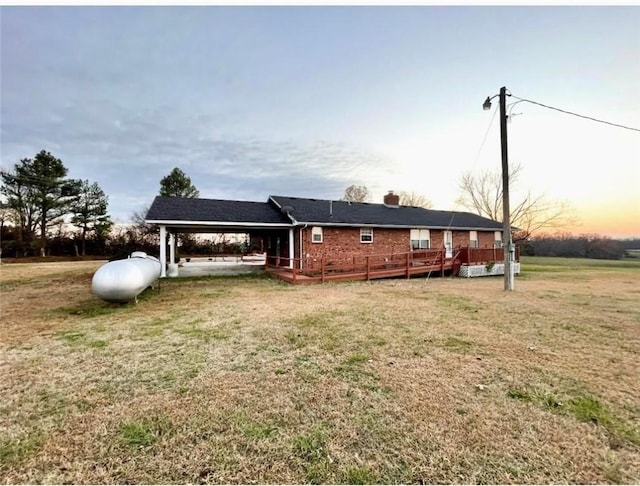 view of front of house featuring a wooden deck and a yard