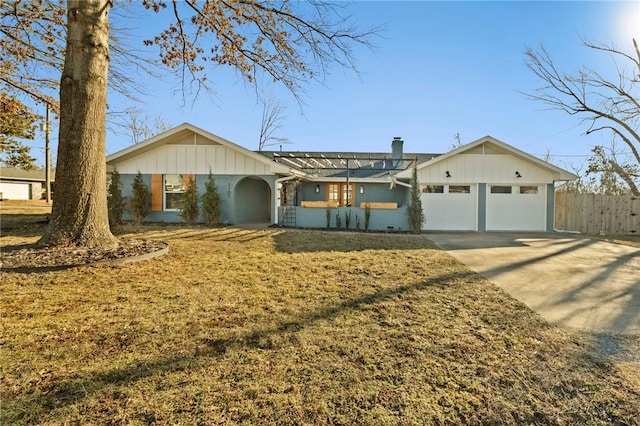 single story home with a garage and a front yard