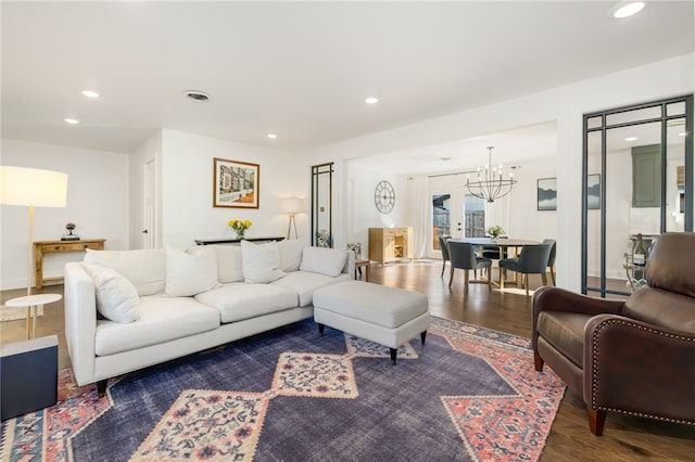 living room featuring dark hardwood / wood-style flooring and a notable chandelier