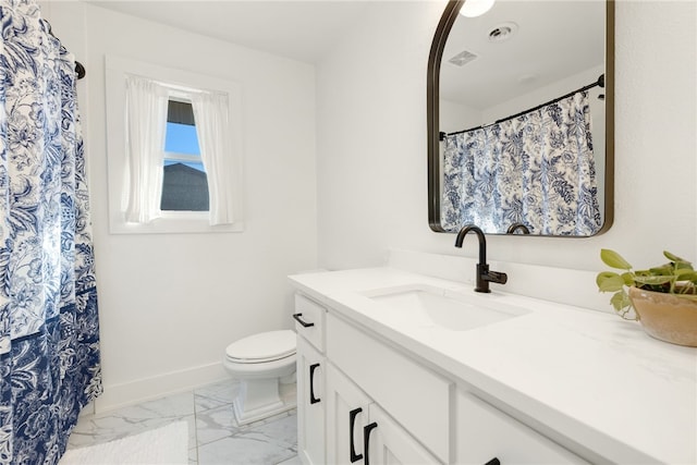 bathroom with vanity and toilet