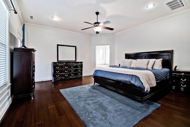 bedroom with crown molding, dark wood-type flooring, and ceiling fan