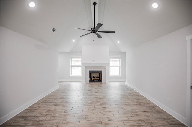 unfurnished living room featuring ceiling fan, high vaulted ceiling, and light wood-type flooring