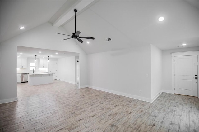 unfurnished living room with beamed ceiling, ceiling fan, sink, and light hardwood / wood-style floors