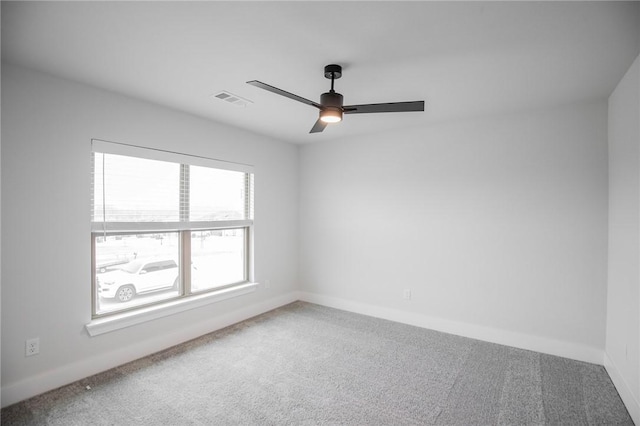 spare room featuring ceiling fan and carpet