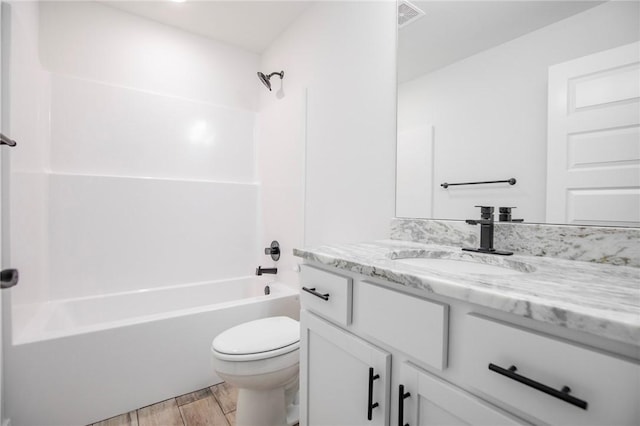 full bathroom with vanity, hardwood / wood-style flooring, toilet, and shower / bathing tub combination