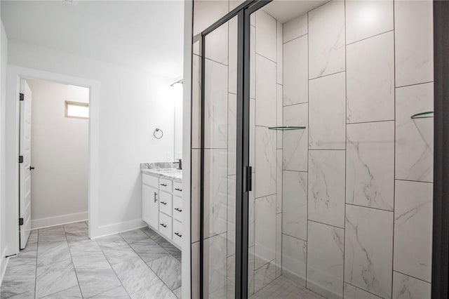 bathroom featuring vanity and a shower with door