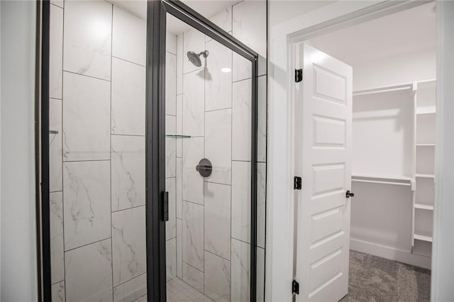 bathroom with a shower with door