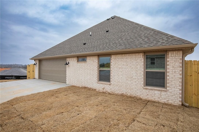 rear view of house featuring a garage