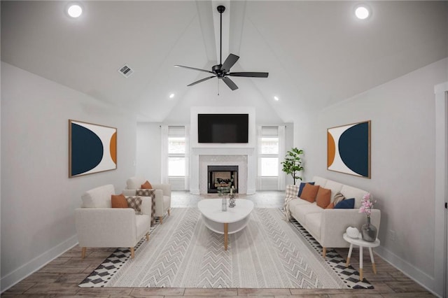 living room with lofted ceiling, hardwood / wood-style flooring, and ceiling fan