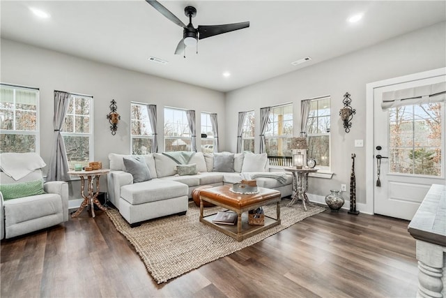 living room featuring a healthy amount of sunlight and dark hardwood / wood-style floors