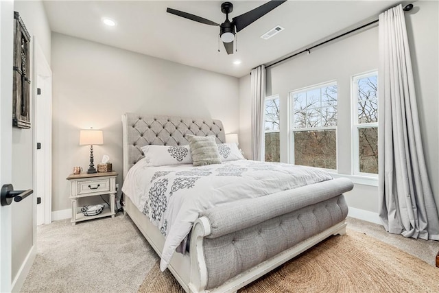 bedroom featuring light colored carpet and ceiling fan