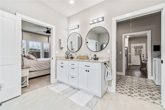 bathroom with vanity, tile patterned floors, and independent washer and dryer