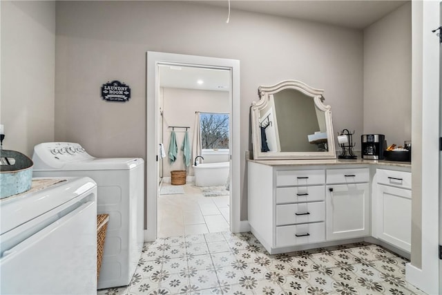 washroom with separate washer and dryer and cabinets