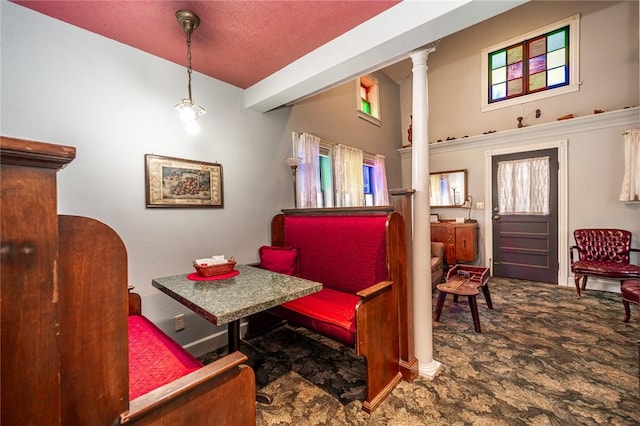 sitting room featuring carpet and ornate columns