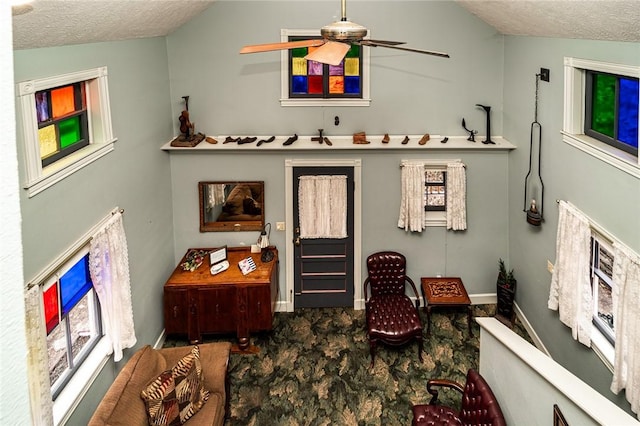 sitting room with ceiling fan and a textured ceiling