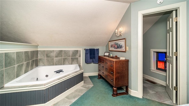 bathroom featuring tile patterned flooring, lofted ceiling, a bath, and a textured ceiling