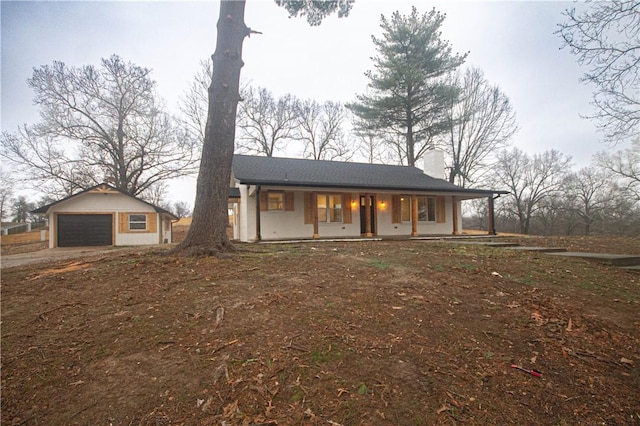 view of front of home featuring an outbuilding, a porch, and a garage