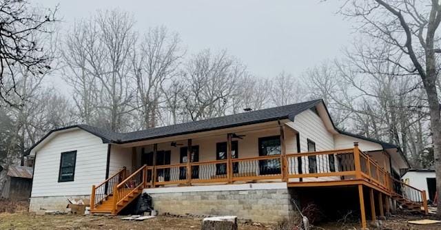 rear view of property featuring stairway