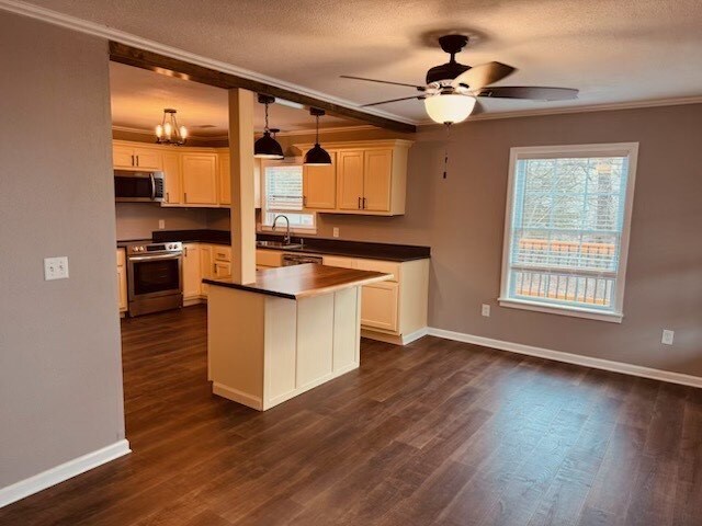 kitchen featuring hanging light fixtures, white cabinetry, appliances with stainless steel finishes, and sink