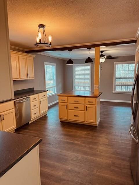 kitchen featuring stainless steel appliances, crown molding, hanging light fixtures, and plenty of natural light