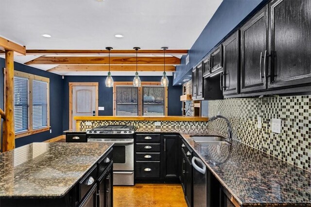 kitchen with tasteful backsplash, appliances with stainless steel finishes, a kitchen island, pendant lighting, and dark stone counters