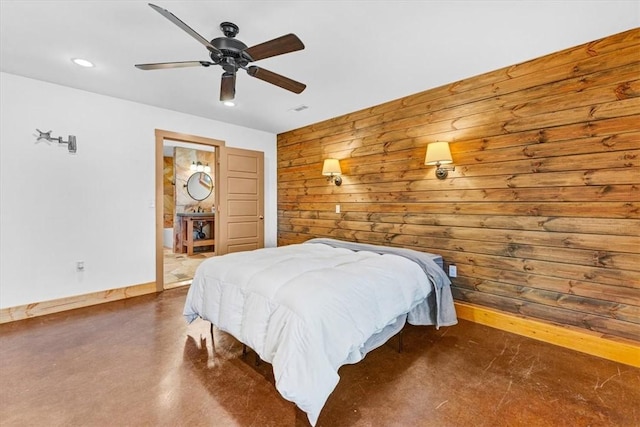 bedroom with connected bathroom, ceiling fan, and wood walls