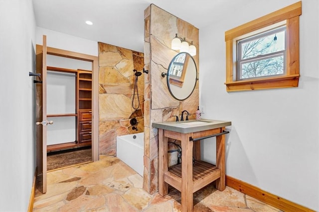 17575 Pear Blossom Dr, Gentry, AR 72734 - bathroom featuring stone finish floors, vanity, shower / bathtub combination, baseboards, and recessed lighting