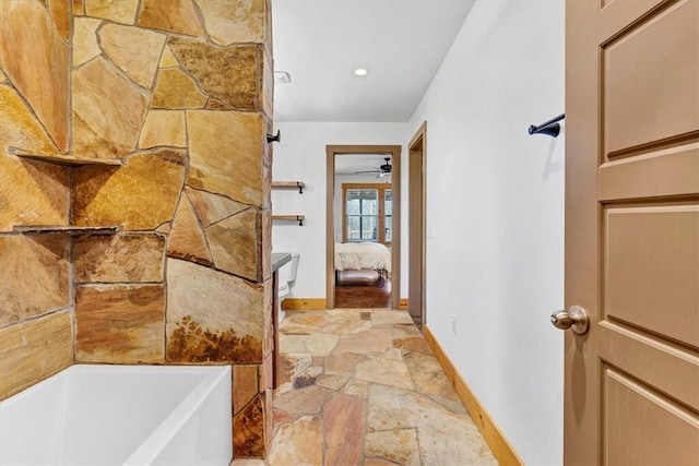 17575 Pear Blossom Dr, Gentry, AR 72734 - bathroom with baseboards, stone finish floors, connected bathroom, a tub, and ceiling fan