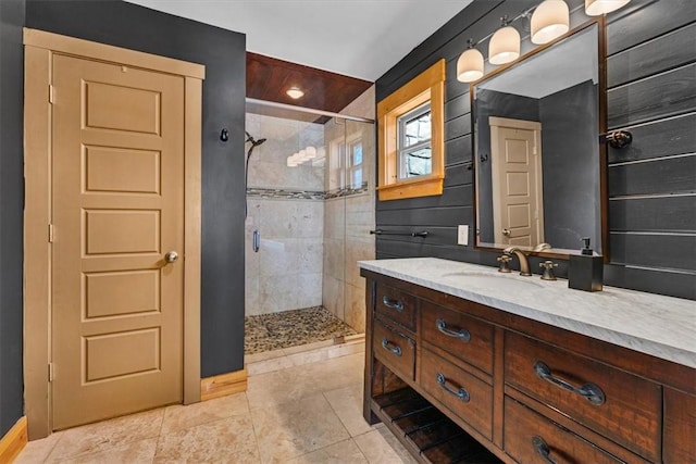 bathroom featuring a shower with door, vanity, and tile patterned flooring