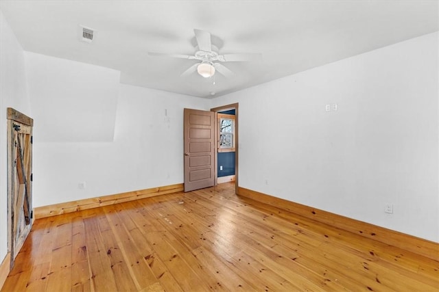 spare room with ceiling fan and light hardwood / wood-style floors