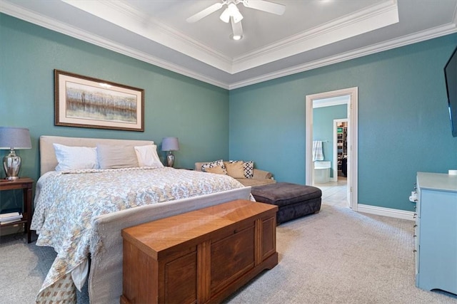 carpeted bedroom featuring ceiling fan, ornamental molding, and a tray ceiling