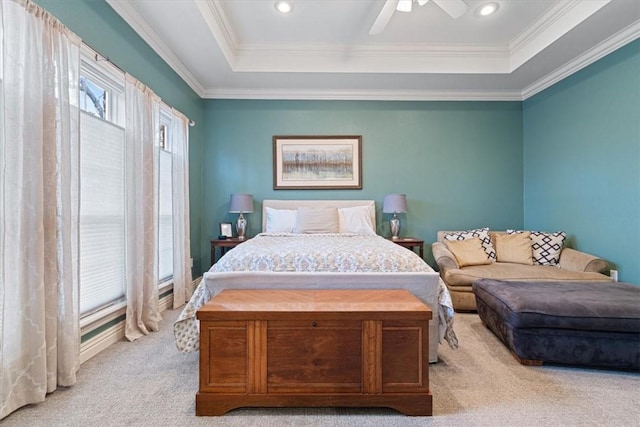 bedroom with ceiling fan, ornamental molding, a raised ceiling, and light carpet