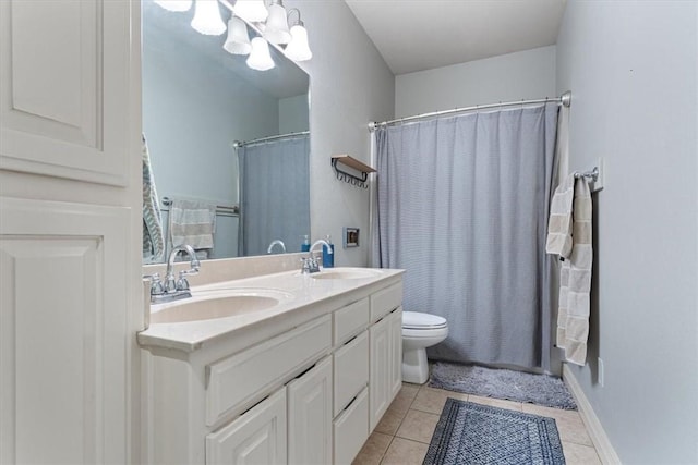 full bathroom with tile patterned flooring, vanity, shower / bath combo with shower curtain, and toilet