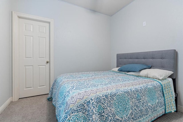 carpeted bedroom featuring baseboards