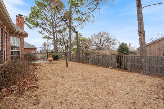 view of yard featuring a patio area and a fenced backyard