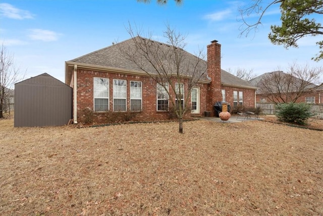 rear view of house featuring a patio and a storage unit