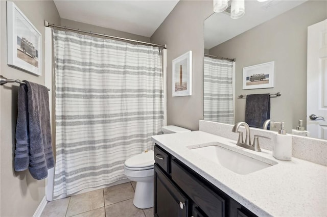 bathroom featuring tile patterned flooring, vanity, and toilet