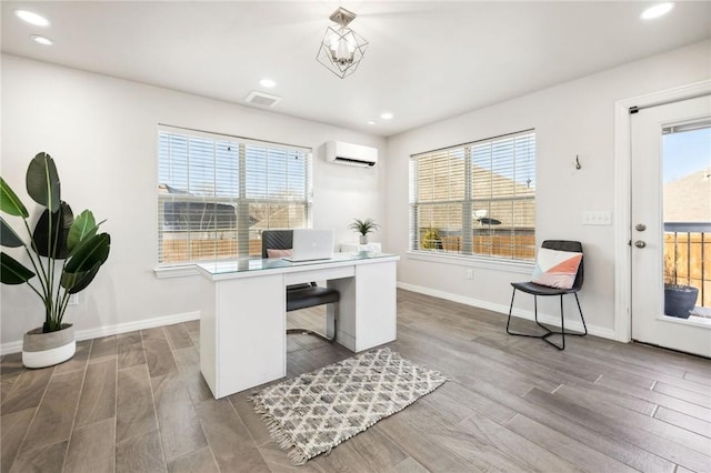 home office featuring hardwood / wood-style floors and a wall mounted AC