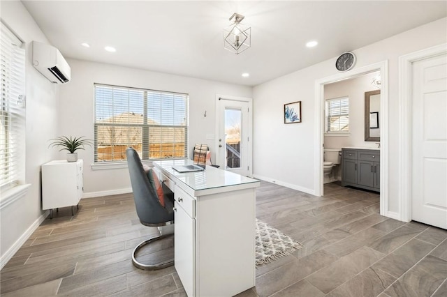 home office featuring light wood-type flooring and an AC wall unit