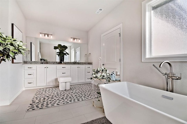 bathroom featuring vanity, a bathtub, and tile patterned floors