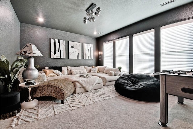 living room featuring light carpet and a textured ceiling