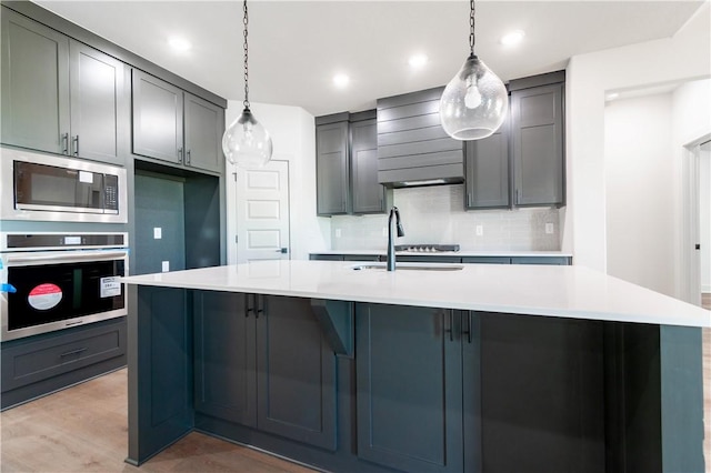 1200 Carrara St, Tontitown, AR 72762 - kitchen featuring appliances with stainless steel finishes, a sink, wall chimney exhaust hood, backsplash, and light countertops