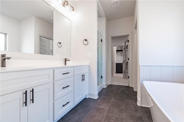 1200 Carrara St, Tontitown, AR 72762 - bathroom featuring a stall shower, a freestanding tub, double vanity, and tile patterned floors