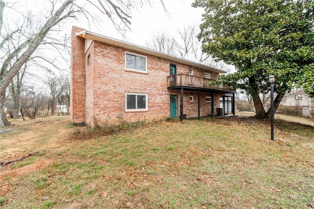 rear view of house with central AC, brick siding, a lawn, and a deck