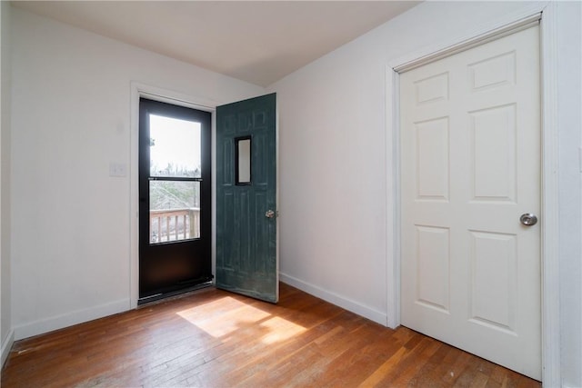 foyer featuring baseboards and light wood-style floors
