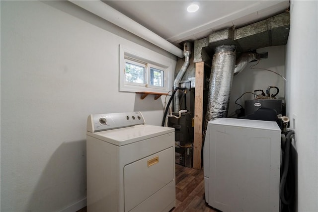 washroom with dark wood-style flooring, independent washer and dryer, and laundry area