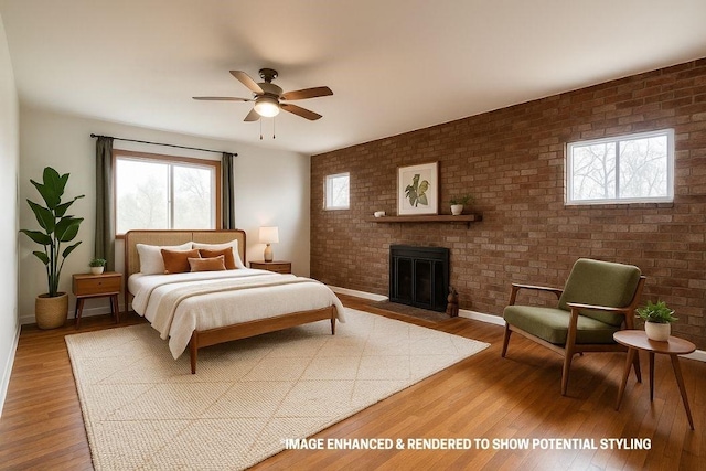 10624 W High Meadows Dr, Rogers, AR 72756 - bedroom with wood finished floors, a fireplace, baseboards, brick wall, and a ceiling fan