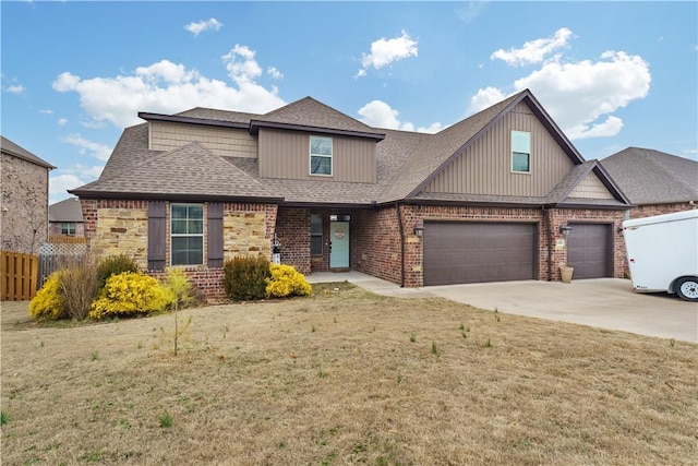 view of front of property featuring brick siding, a shingled roof, fence, driveway, and a front yard