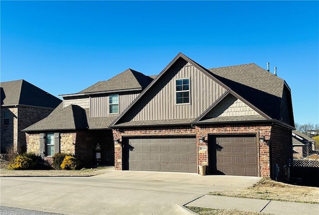 view of front of house featuring driveway, brick siding, and roof with shingles