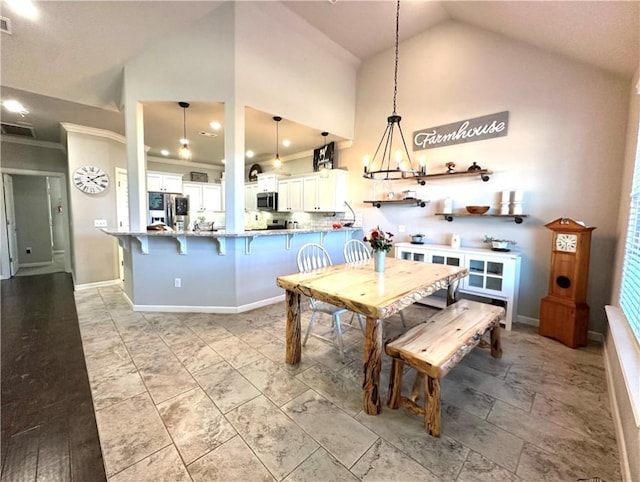 dining space with ornamental molding, baseboards, visible vents, and high vaulted ceiling